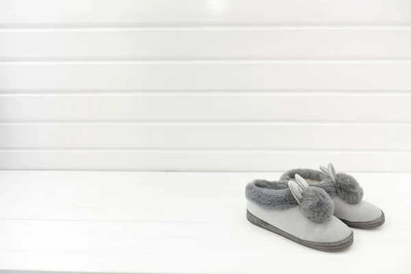 Beautiful fur slippers in the form on a white background, concept of comfort in the house