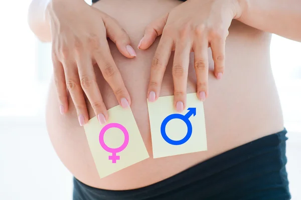 Беременная женщина с символами хромосом — стоковое фото