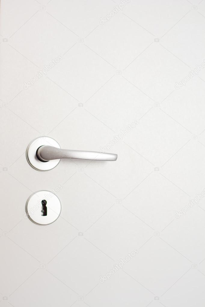 door handle and lock on white door 