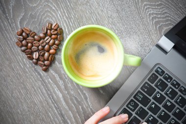 coffee cup with laptop and heart of beans clipart