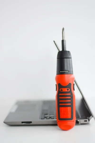 Laptop and red screwdriver — Stock Photo, Image