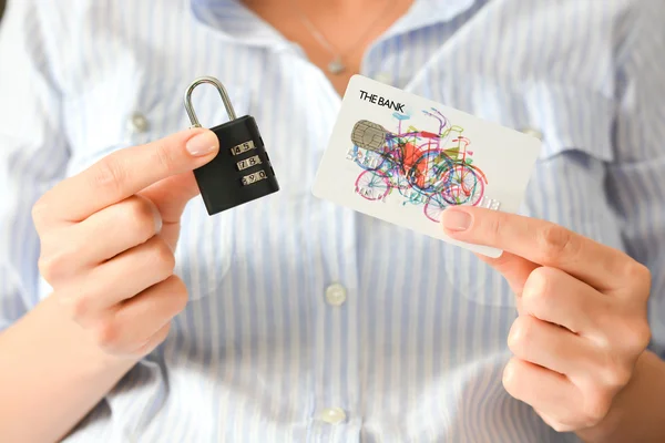 Female hands holding padlock and credit card — Stock Photo, Image