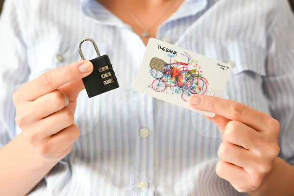 Female hands holding padlock and credit card — Stock Photo, Image