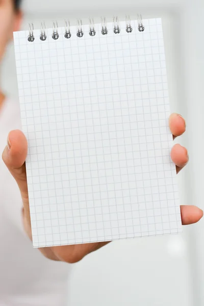 Notebook in hand with text space — Stock Photo, Image