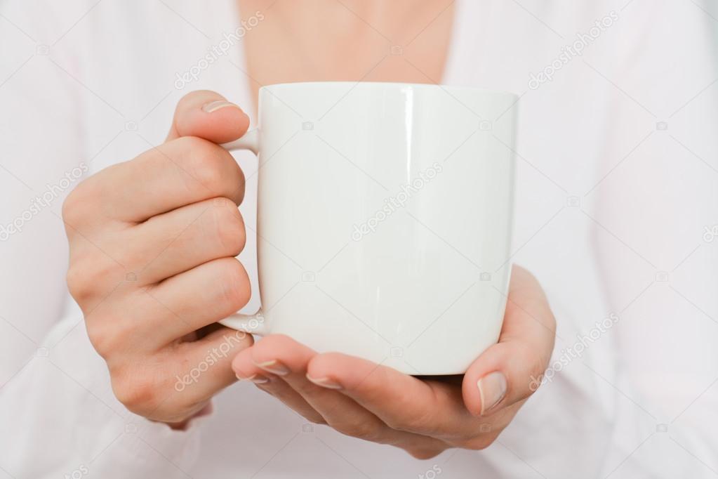 white coffee cup held by woman