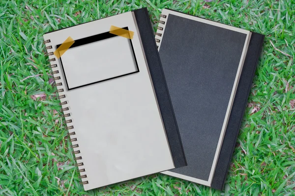 Twin notebook on the grass. — Stock Photo, Image