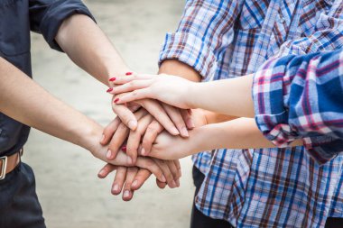 Takım çalışması konsepti. İş adamları el ele tutuşuyor. Takım çalışması konsepti, iş ekibinin çatı katında el ele tutuşması. İşbirliğine katılan insanlar, başarı işi, her şeyde kazanmak, klasik renk.