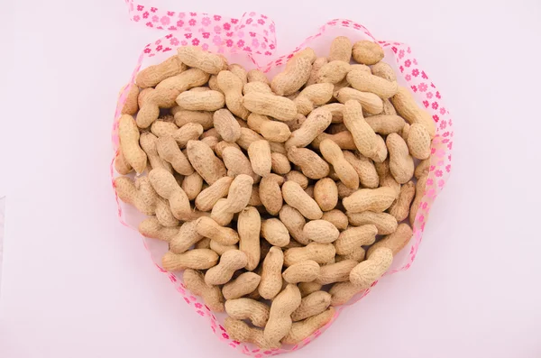 Groundnuts in shape of heart Royalty Free Stock Photos