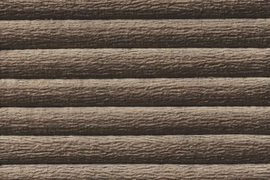 Dark brown horizontal logs fence modern interior wood texture background.