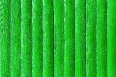 Çit tahtalarındaki yeşil boya yüzey ahşap doku arka planı.