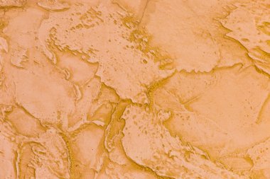 Orange-brown wall texture with abstract background pattern.