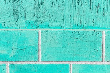 Aquamarine or azure paint on the wall of brick blocks with cracked texture background.