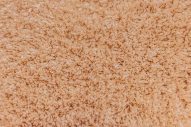 Soyut yumuşak desenli açık turuncu halı dokusu.