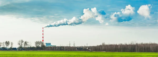 Environmental pollution, environmental problem, smoke from the chimney of an industrial plant or thermal power plant against a cloudy sky, panoramic view, high resolution.