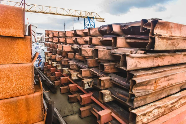 Eski paslı metal malzeme ve yapıların olduğu açık bir depoda..