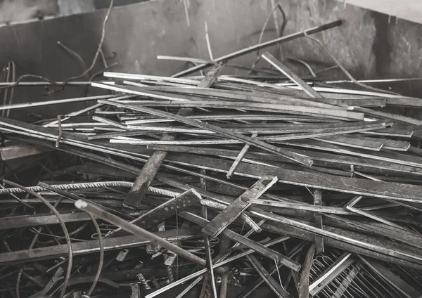 A pile of metal waste in the urn of an industrial plant. Recycling of iron waste and trash.