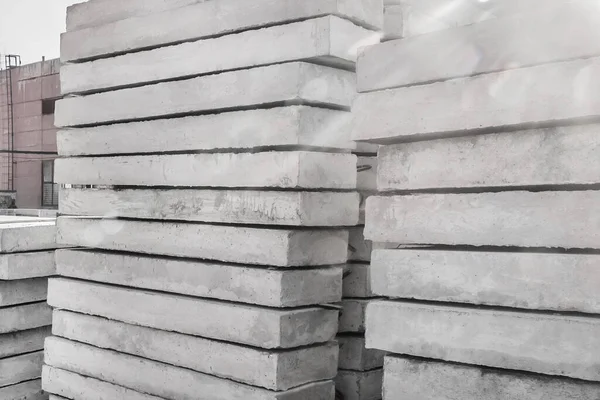 Storage of concrete blocks in a warehouse. Concrete structures at the construction site. Industrial, building cement materials.