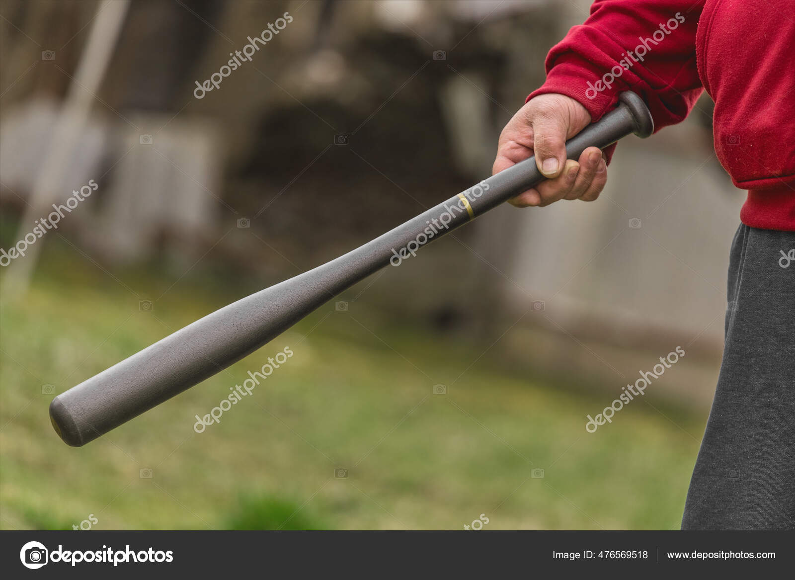 Man's Hand Holds Baseball Bat Background Street Outdoors Stock Photo by