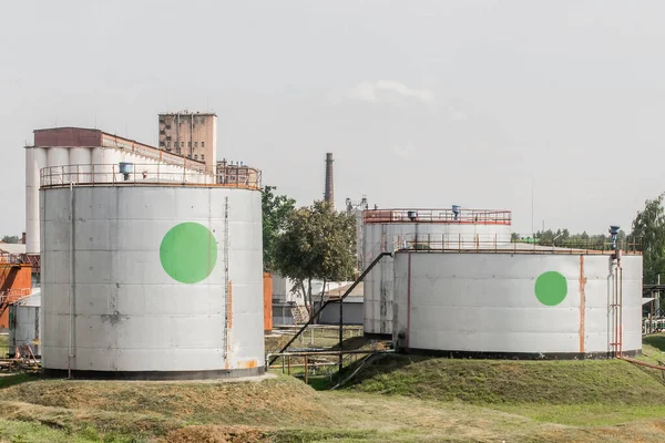 Industrial tanks for storage of oil or chemical products, fertilizers in the area of the plant at the enterprise.