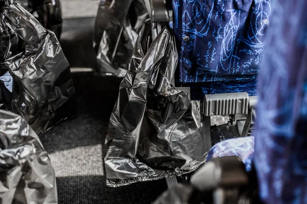 Black bags for garbage and waste in the cabin of tourist transport of the bus.