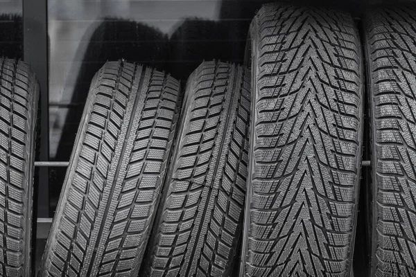 Car tires for the vehicle are stored for sale at the gas station.