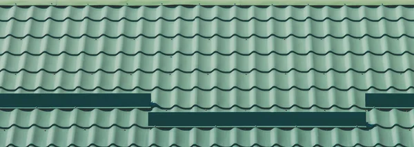 Metal structure iron tile roof covering house background.