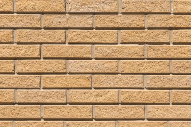 Kum sarısı tuğla duvar yüzey dokusu arkaplanı.