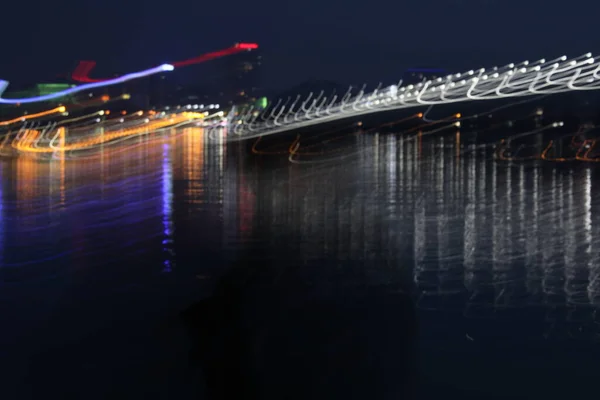 Cidade noturna como é belas luzes no fundo do rio — Fotografia de Stock