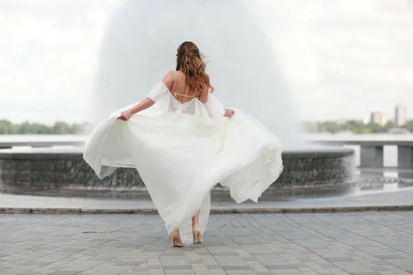 A person standing in front of water Stock Image