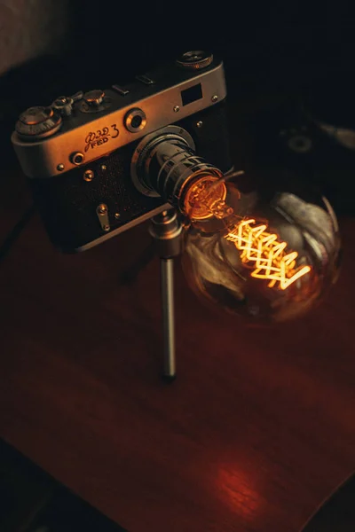 Cool night lamp with delicate yellow light as a camera — Stock Photo, Image