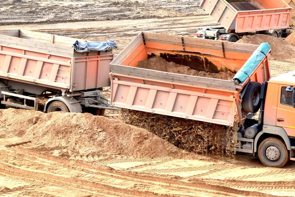 modern truck unloads a large pile of sand from the body