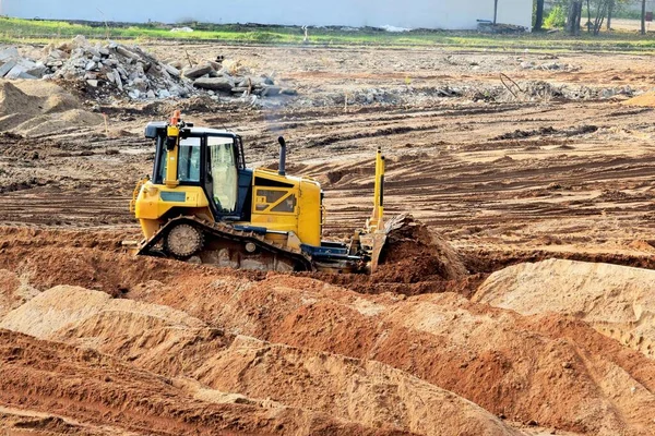 bulldozer on construction site job of burying the old building