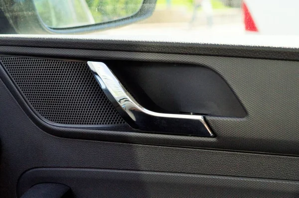 The inner door handle, the car interior detail
