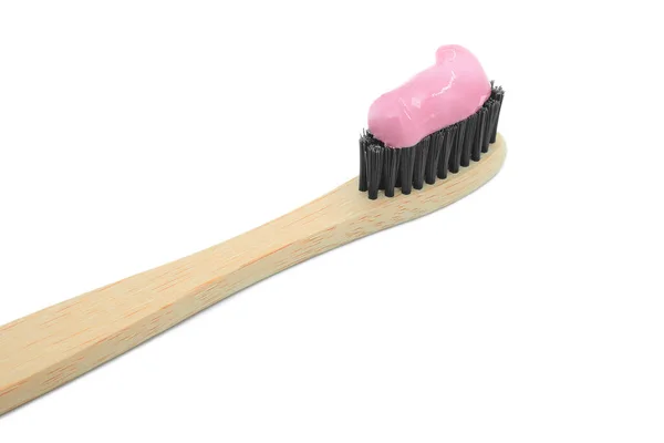 Fechar a escova de dentes de bambu com pasta de dentes rosa isolada no fundo branco. Conceito de higiene oral pessoal. — Fotografia de Stock