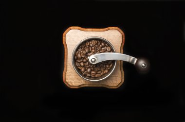 Coffee mill isolated on black background clipart
