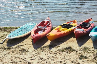 Kayaks in many colours on a beach
