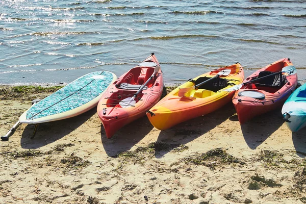 Kayaks in many colours on a beach — 스톡 사진