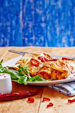 ahşap masa üstünde kırmızı pul biber ile Meksika böreği yemek