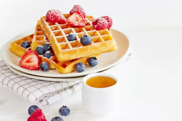 Waffles with berries on a white plate — Stock Photo, Image