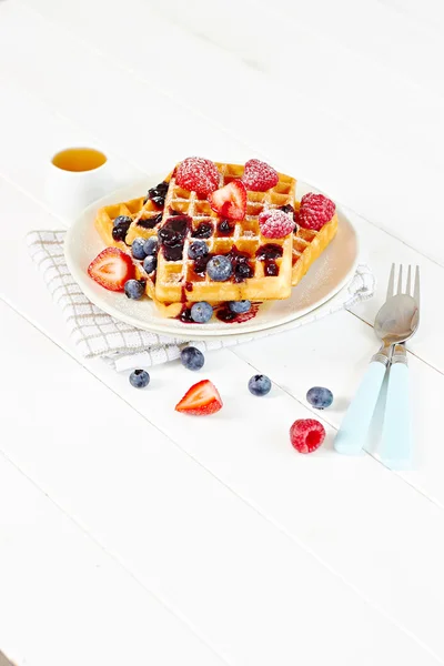 Waffles with berries and honey on a plate — Stock Photo, Image