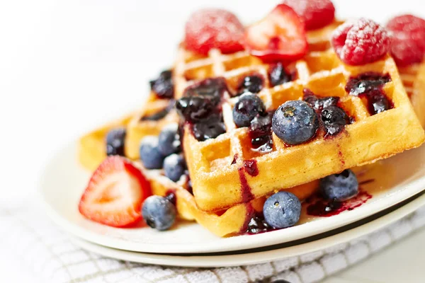 Waffles with berries on a white plate — Stock Photo, Image