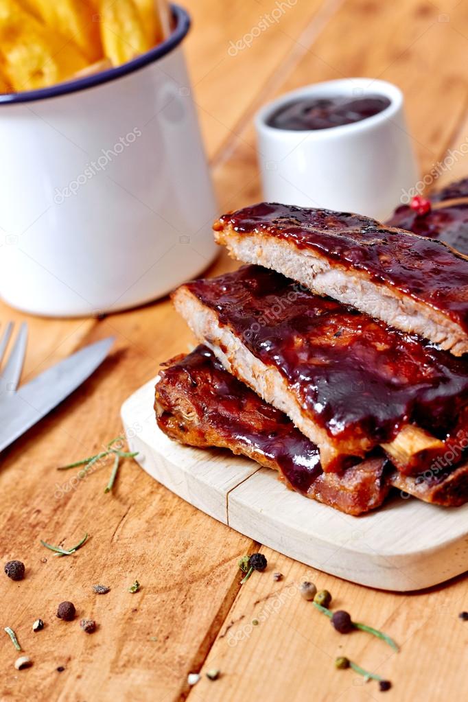 Barbecue ribs with fries on table — Stock Photo © chrisbm 52689045