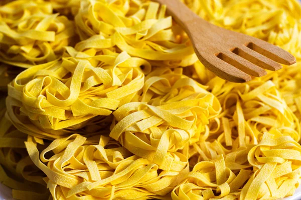 Raw tagliatelle pasta — Stock Photo, Image