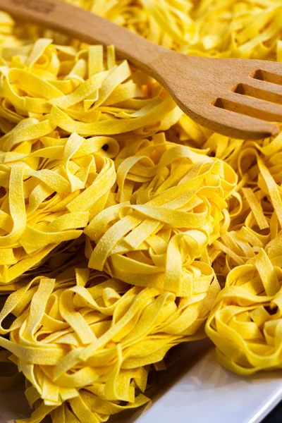 Raw tagliatelle pasta — Stock Photo, Image