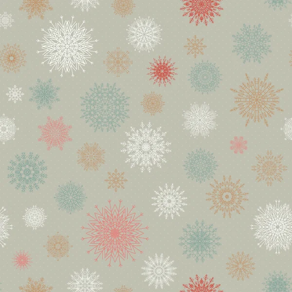 Christmas seamless pattern from red andblue snowflakes on a pastel background. — Stock vektor