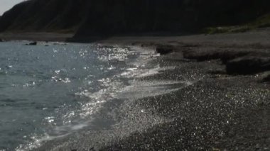 Dalgalar deniz taşlı kayalar plajda sörf. Japonya deniz.