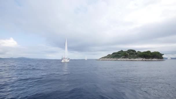 Jachty żaglowe statek z białe żagle na otwartym morzu. — Wideo stockowe