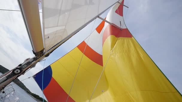 Vícebarevné plachtu vane vítr na lodi. — Stock video