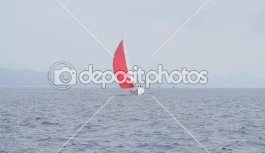 İle açık deniz kırmızı yelken yelkenli yatlar.