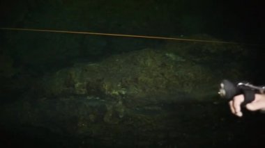 Yucatan Meksika 'nın sualtı mağaralarındaki kayalıklarda dalgıçlar.